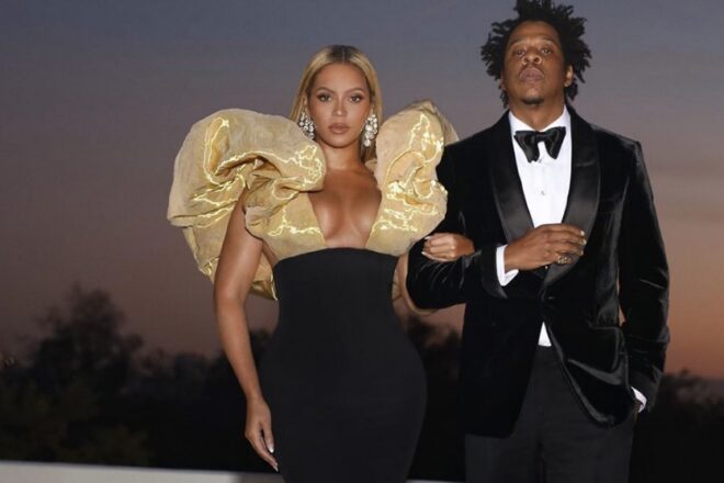Rapper Jay-Z and Beyonce sit during National Anthem